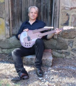 Chris Braddock performing solo on guitar